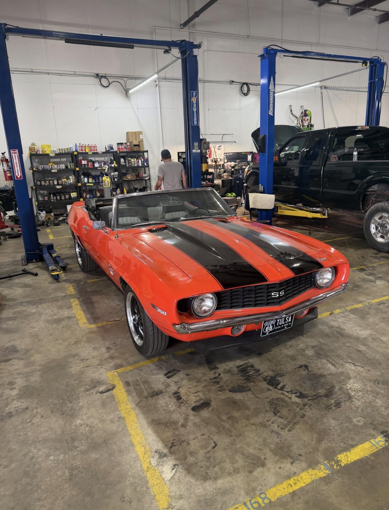 Orange 1969 Camaro SS convertible in the Insanity Customs service bay